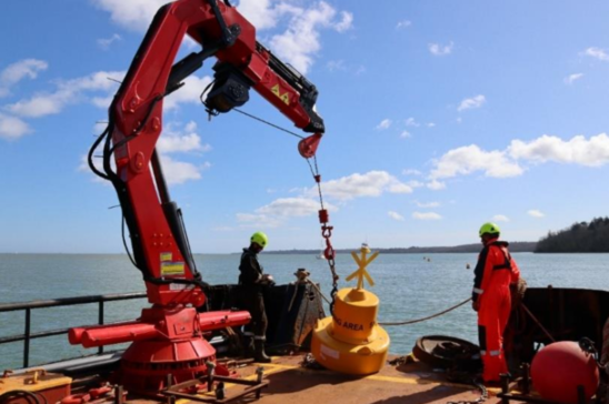 Vessel installing marker buoy with a train wheel sinker in Osborne Bay